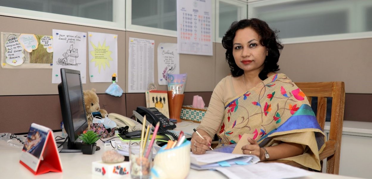 Liza Fahmida working at her office desk