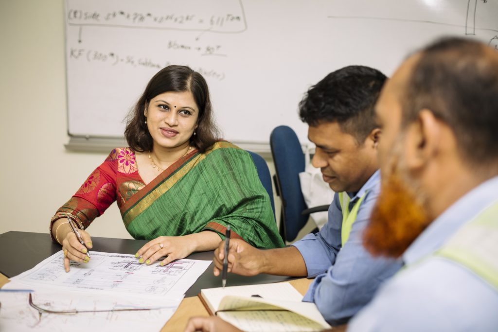 Asfia (left) featured with her colleagues at work.