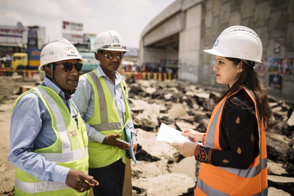 Asfia (right) interacting with workers at the Kanchpur Bridge construction site on the Dhaka-Chittagong highway.